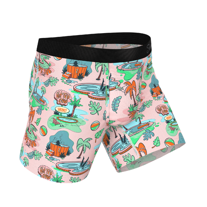 Colorful swim shorts with a tropical pattern on a white background