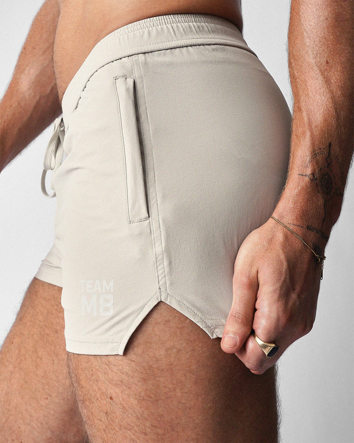 TEAMM8 Pace 2.5 inch gym short in ecru – scallop leg split performance short