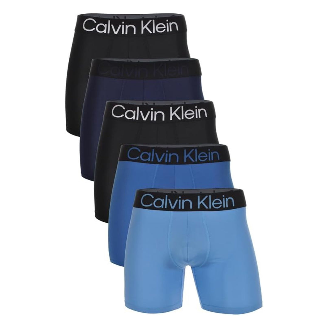 Calvin Klein Bold Logo 5-pack boxer briefs in black, navy, and blue, flat lay on white background